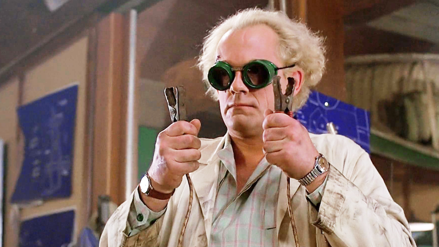 doc brown wearing goggles and holding jumper cables